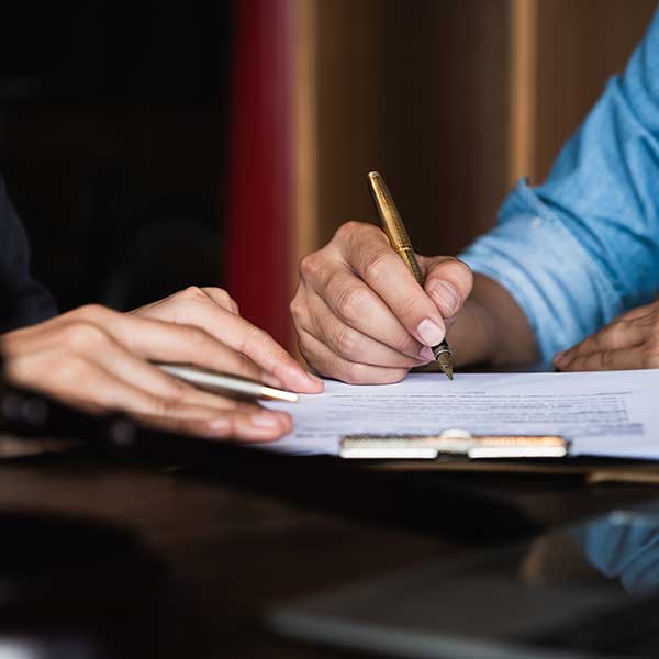 Man writing on a paper in a court