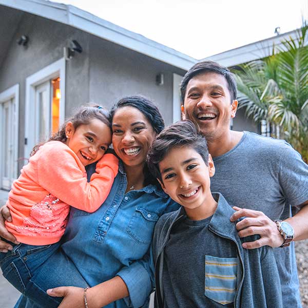 Happy family in front of the house