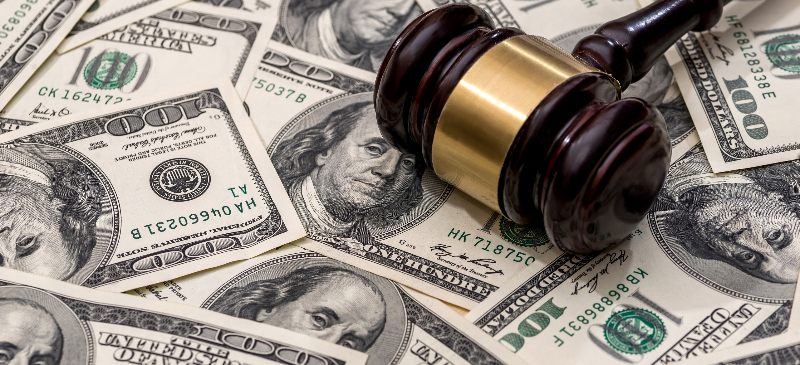 A gavel on top of money by the Law Offices of Robert E. O’Connor